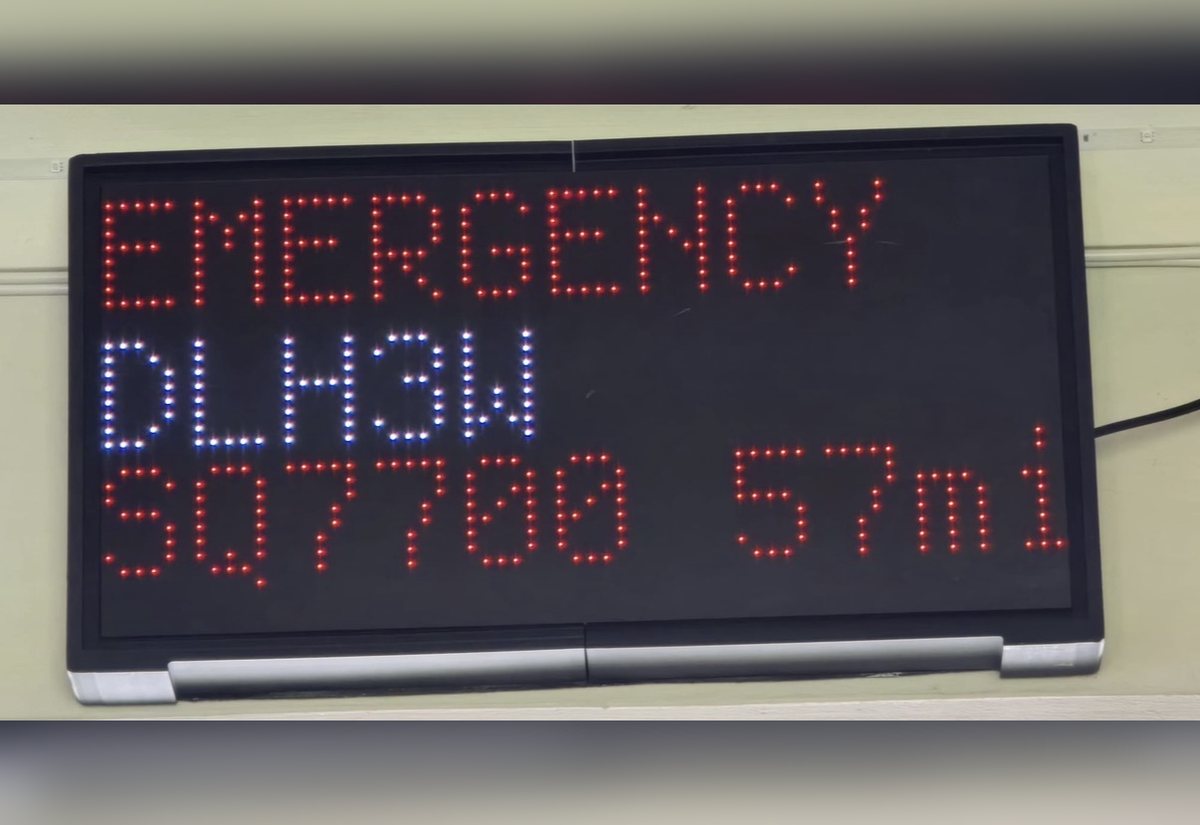 NearestPlane display turning red with an EMERGENCY alert, showing a Lufthansa flight squawking 7700 fifty-seven miles away