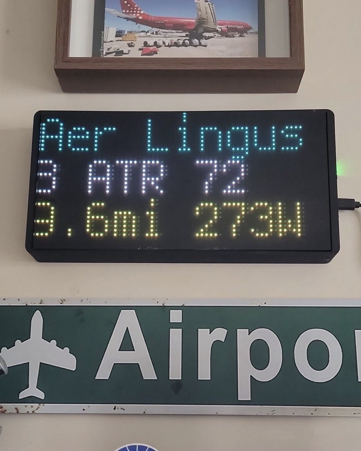 Wall-mounted NearestPlane display in a room of aviation memorabilia, showing an Aer Lingus ATR 72 three miles away